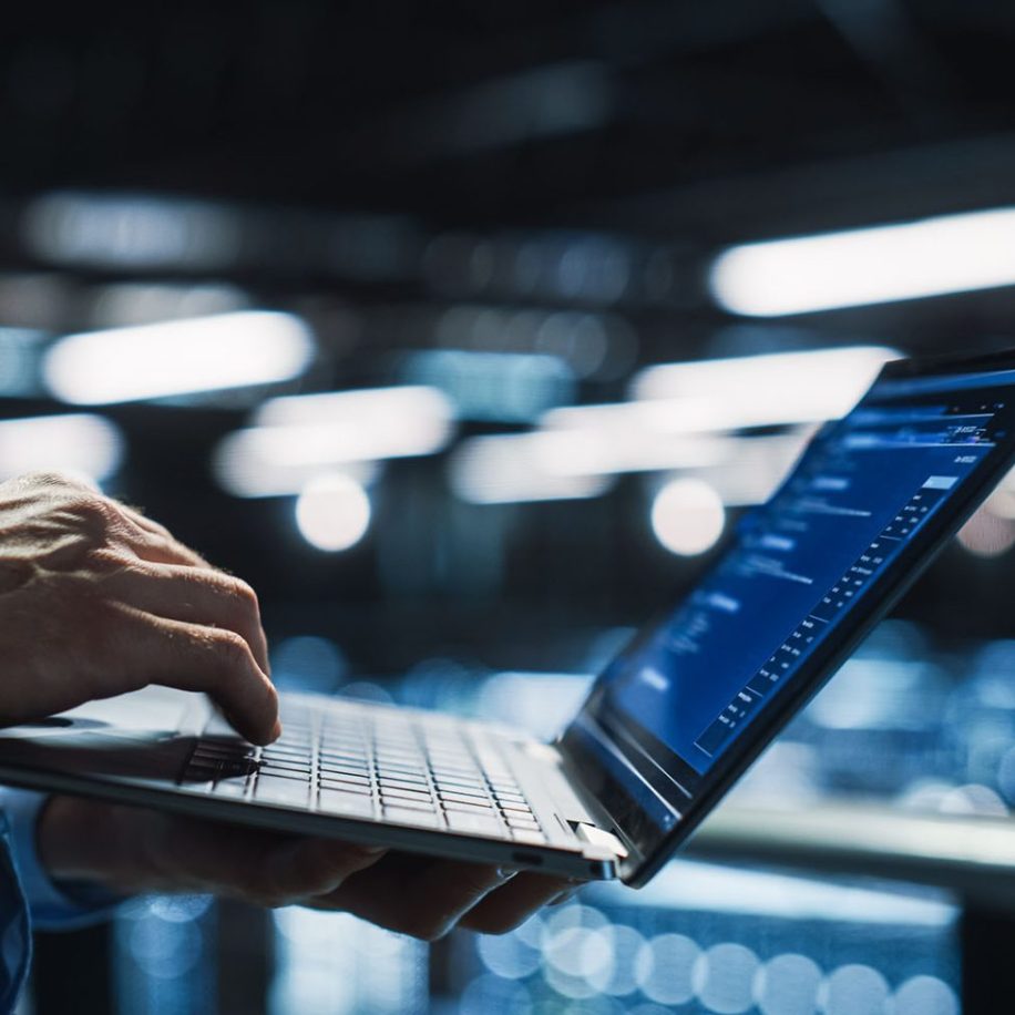 Data-Center-Programmer-Using-Digital-Laptop-Computer-Maintenance-IT-Specialist.-Cloud-Computing-Server-Farm-System-Administrator-Working-on-Cyber-Security-aspect-ratio-1600-975