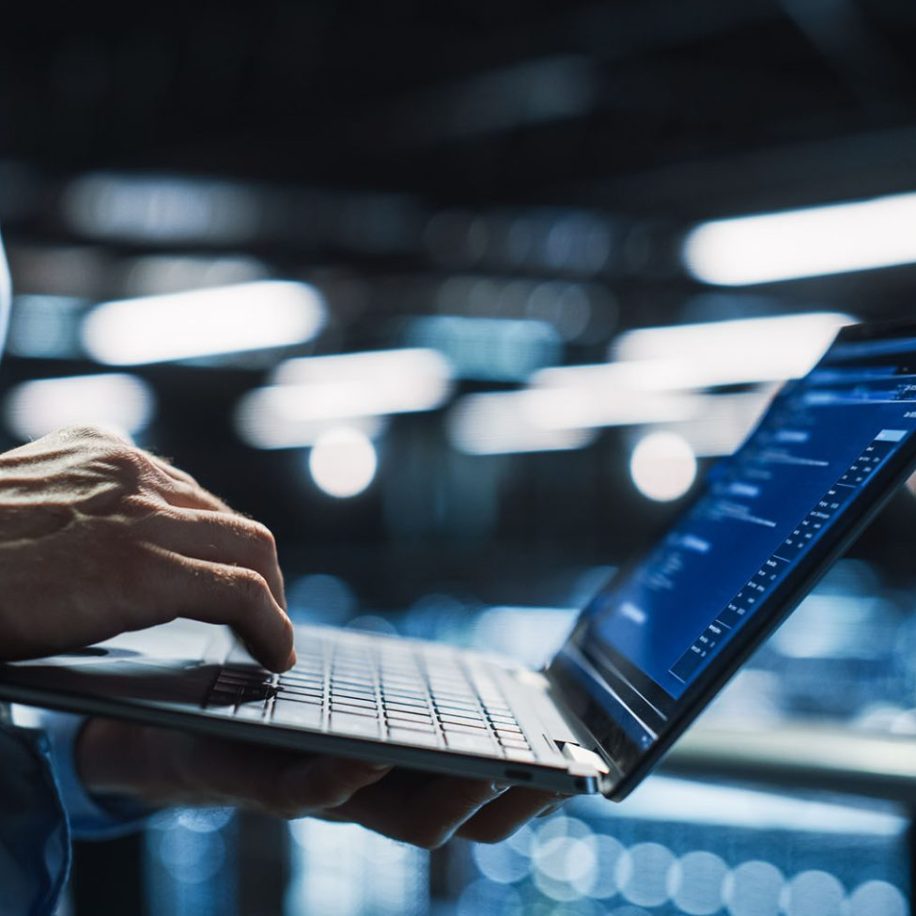 Data-Center-Programmer-Using-Digital-Laptop-Computer-Maintenance-IT-Specialist.-Cloud-Computing-Server-Farm-System-Administrator-Working-on-Cyber-Security-aspect-ratio-1600-975