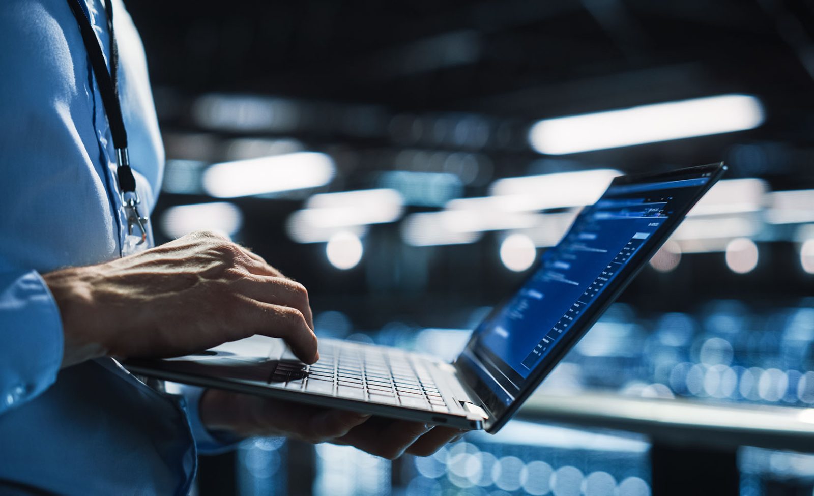 Data-Center-Programmer-Using-Digital-Laptop-Computer-Maintenance-IT-Specialist.-Cloud-Computing-Server-Farm-System-Administrator-Working-on-Cyber-Security-aspect-ratio-1600-975