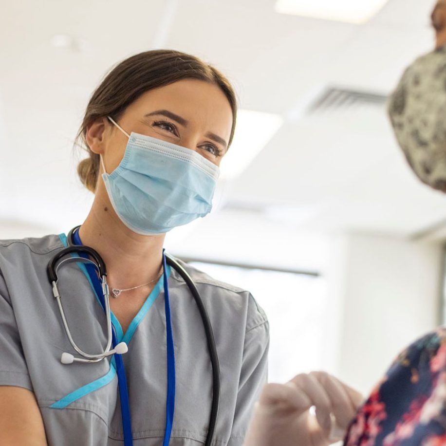 Friendly-nurse-preps-patient-prior-to-COVID-19-vaccine-shot-aspect-ratio-1600-975