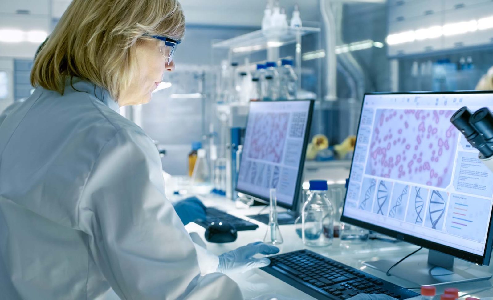 enior-Female-Scientist-Works-On-Computer-in-a-Modern-Laboratory-aspect-ratio-1600-975